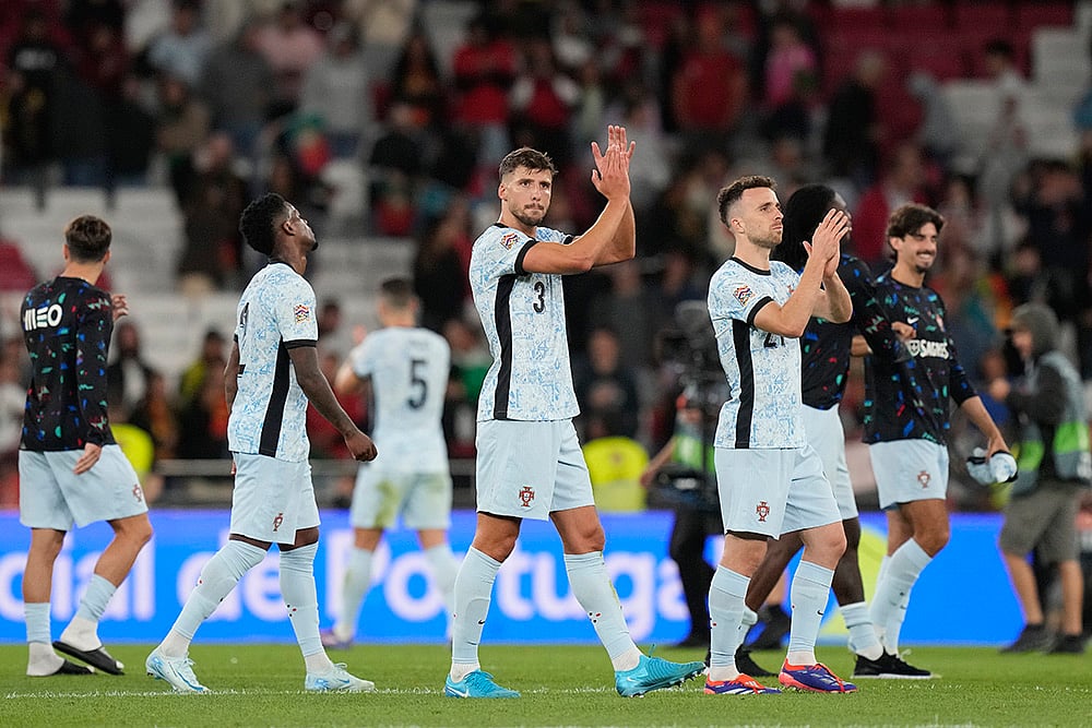 | Photo: AP/Armando Franca : 2024-25 Nations League Football Portugal vs Croatia: Portugal's Ruben Dias, center, and Portugal's Diogo Jota, right, applaud the crowd after the match